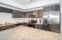 Modern kitchen with sleek stainless steel appliances, granite countertops, and elegant dark wood cabinetry.