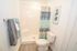 Tastefully designed bathroom with modern fixtures, featuring a cozy shower and elegant decor.