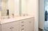 Elegant bathroom with dual sinks, sleek modern fixtures, and a bright, inviting atmosphere.