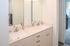 Modern bathroom with dual vanity sinks, sleek finishes, and contemporary fixtures.