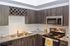 Elegant kitchen design featuring sleek granite countertops, modern appliances, and a stylish wine rack.