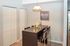 Modern dining area with a sleek wooden table, stylish chairs, and chic lighting, perfect for intimate gatherings.
