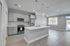 Modern open-concept kitchen with sleek stainless steel appliances and elegant pendant lighting.