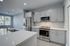 Modern kitchen with sleek stainless steel appliances, elegant cabinetry, and a bright, spacious island countertop.
