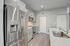 Modern kitchen featuring sleek stainless steel appliances, elegant white cabinetry, and a polished countertop for a sophisticated look.
