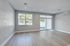 Bright and spacious open living area featuring elegant wood flooring, large windows, and abundant natural light.