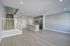 Modern open-concept living area with sleek kitchen, elegant wooden floors, and contemporary staircase design.