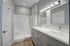 Elegant modern bathroom with dual sinks, sleek vanity, and bright lighting, perfect for a luxury apartment.