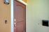 Inviting brown front door with modern doorbell and chic mailbox, enhancing the entrance's elegant style.