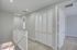Bright and airy hallway with plush carpeting and stylish white doors, offering a glimpse into modern comfort.