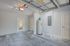Spacious modern garage with a sleek water heater, abundant natural light, and convenient access to outdoor greenery.