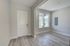 Bright entryway with modern wood flooring, large window for natural light, and sleek recessed lighting.