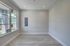 Bright, modern interior with sleek flooring, large window, and subtle recessed lighting.