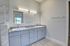 Elegant bathroom with dual sinks, modern fixtures, and sleek marble accents for a luxurious touch.