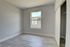 Bright and airy bedroom with large window, modern flooring, and spacious closet, perfect for personalization.