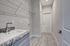 Modern laundry room with sleek granite countertop, spacious sink, and convenient shelving against a bright, contemporary design.
