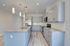Sleek modern kitchen with elegant gray cabinetry, polished granite countertops, and stylish pendant lighting.
