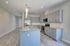 Gorgeous modern kitchen with sleek gray cabinets, an elegant island, and stainless steel appliances, offering plenty of space and style.