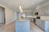Modern kitchen with sleek gray cabinetry, granite countertops, and stainless steel appliances, ideal for culinary enthusiasts.