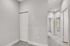 Bright and inviting hallway with plush carpeting, showcasing modern design and ample natural light.
