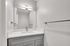 Sleek and modern bathroom vanity with a stylish marble countertop, contemporary lighting, and elegant silver fixtures.