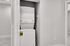 Modern apartment feature with convenient in-unit stacked washer and dryer in sleek, compact space.
