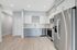 Modern kitchen featuring sleek stainless steel appliances, elegant white and gray cabinetry, and stylish hardwood flooring.