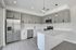 Modern kitchen with sleek gray cabinetry, stainless steel appliances, and elegant pendant lighting creating a stylish cooking space.