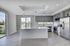 Modern open-concept kitchen with sleek stainless steel appliances, stylish pendant lighting, and large windows offering scenic views.
