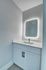 Elegant bathroom vanity with a sleek LED-lit mirror and contemporary faucet, perfect for modern living.