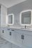 Sleek bathroom design with dual sinks, illuminated mirrors, and elegant cabinetry for modern living.