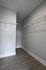 Spacious modern walk-in closet with sleek wire shelving and elegant wood flooring, perfect for organized storage.