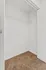 Spacious walk-in closet with plush carpeting and modern shelving, ideal for ample storage.