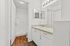 Modern bathroom design featuring sleek white cabinets, a polished vanity, and elegant lighting.