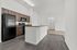 Modern apartment kitchen with sleek dark wood cabinets, elegant countertops, and high-quality appliances, offering a perfect blend of style and functionality.