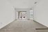 Inviting apartment living space featuring plush carpeting, bright natural light, and a view of a charming balcony.