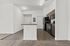 Modern apartment kitchen with sleek appliances and stylish open layout.