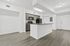 Modern open kitchen with sleek countertops and stainless appliances, flowing seamlessly into bright living space with elegant wood flooring.