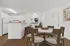 Bright and inviting dining area with modern kitchen, featuring sleek countertops, elegant dining table, and stylish decor accents.