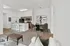 Modern open-concept living space featuring a stylish kitchen with sleek bar seating, chic dining area, and cozy lounge seating.