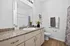 Elegant bathroom showcasing a granite countertop, sleek vanity, and tasteful decor accents.