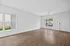 Bright, spacious living room with modern wood flooring and large windows offering plenty of natural light.