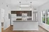 Bright, contemporary kitchen with elegant granite countertops, sleek dark cabinetry, and modern appliances in an inviting open layout.