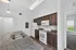 Contemporary kitchen with sleek granite countertops, stylish dark wood cabinetry, and modern appliances.
