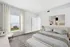 Bright and modern bedroom with elegant decor, large window, and cozy atmosphere for relaxation.