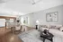 Bright and modern open-concept living room with elegant dining area and sleek kitchen appliances.