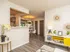 Inviting open-concept living space with elegant decor, featuring hardwood floors, a cozy nook, and a warm dining area.