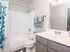 Modern and bright bathroom featuring a sleek vanity, elegant fixtures, and a refreshing shower-tub combo.