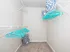 Spacious walk-in closet with bright teal hangers and stylish storage baskets, featuring sleek white shelving and plush carpet flooring.