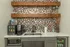 Modern kitchenette with sleek marble countertop, hexagonal mosaic backsplash, and floating wooden shelves. Includes coffee maker, microwave, and mini fridge stocked with beverages.